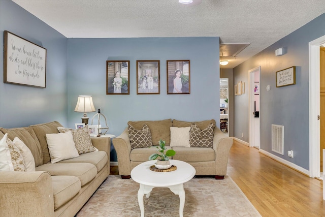 120 Stone St, Harlem, GA 30814 - living room with attic access, wood finished floors, and a textured ceiling