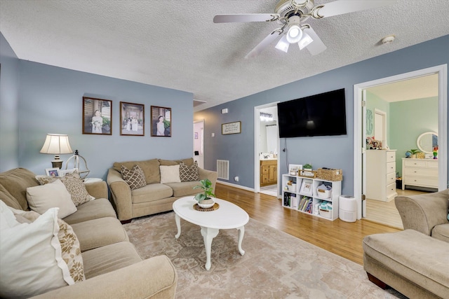 120 Stone St, Harlem, GA 30814 - living room with wood finished floors, ceiling fan, and a textured ceiling