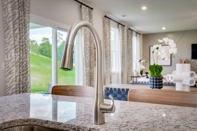 interior space with light stone counters and recessed lighting