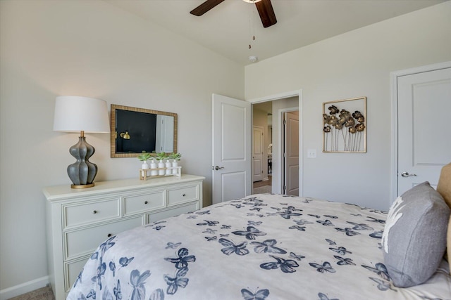 bedroom with a ceiling fan, vaulted ceiling, and baseboards