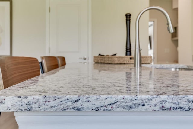 interior details with light stone countertops and white cabinets