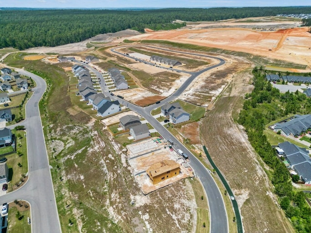 bird's eye view featuring a forest view and a residential view