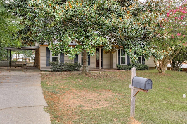 obstructed view of property featuring a front lawn and a carport