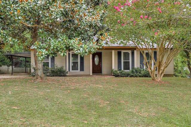 view of front of house with a front yard and a carport