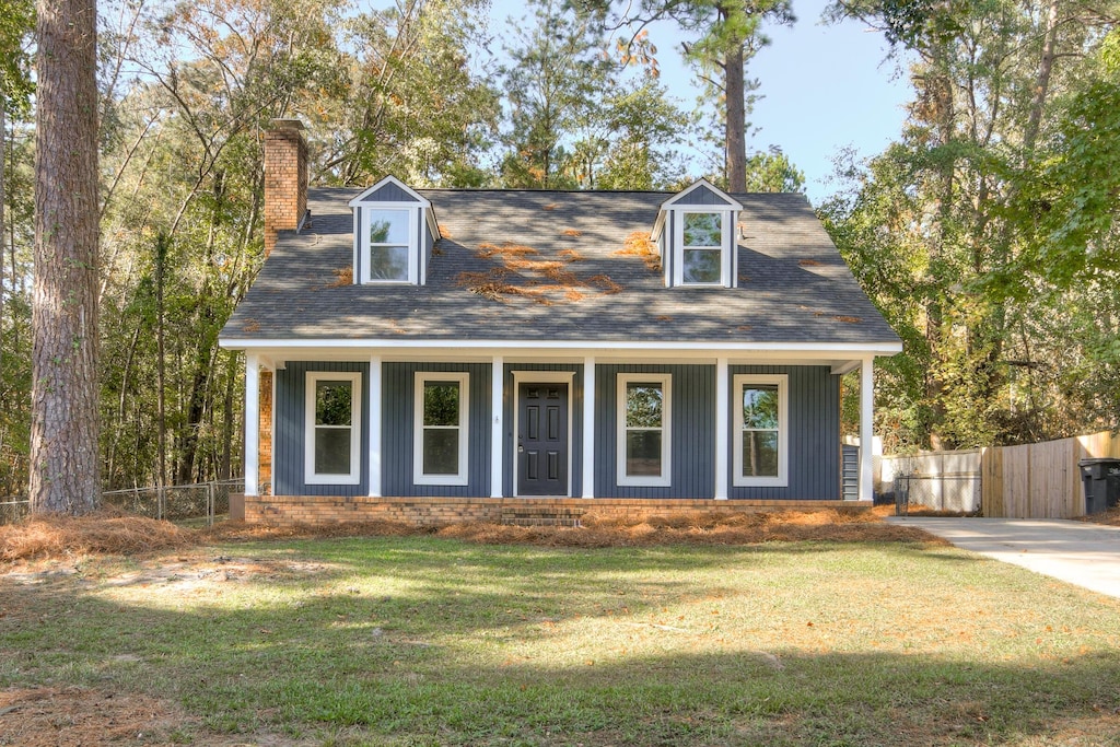 cape cod-style house with a front yard