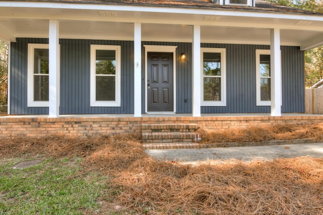 view of exterior entry with covered porch