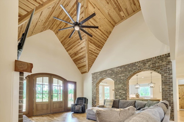 living room with wood ceiling, high vaulted ceiling, and light hardwood / wood-style floors