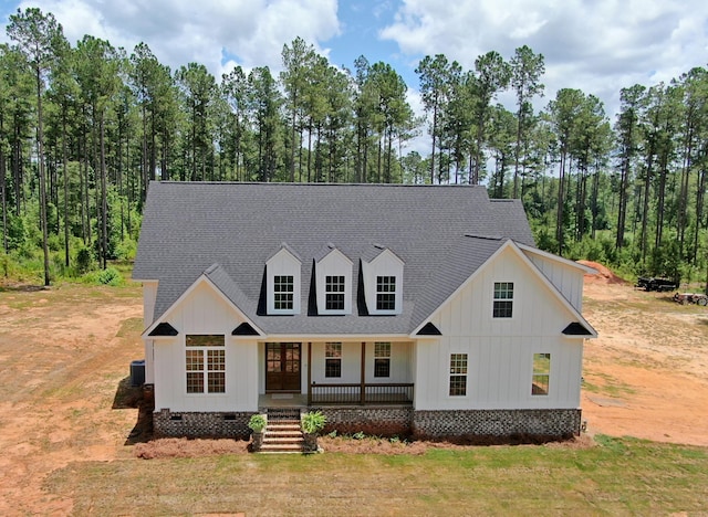 view of front of property featuring covered porch and cooling unit