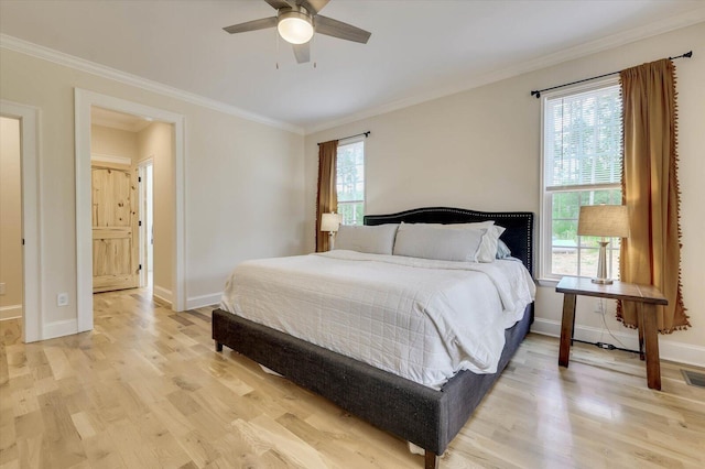 bedroom with ceiling fan, light wood-type flooring, and crown molding