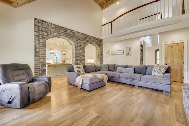 living room with high vaulted ceiling, wood ceiling, and light wood-type flooring