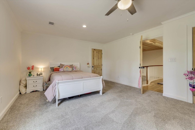 bedroom with light colored carpet, ceiling fan, and crown molding