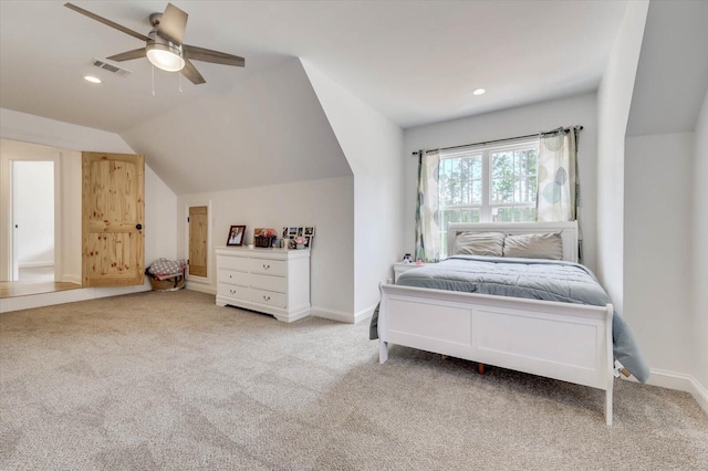 bedroom featuring ceiling fan, light colored carpet, and vaulted ceiling