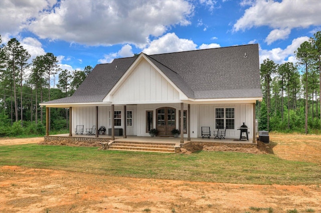 view of front of house featuring central AC, a front lawn, and covered porch