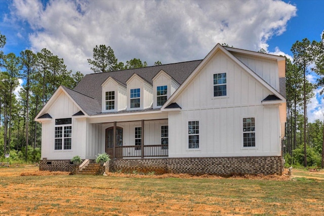 view of front of property with covered porch and a front yard