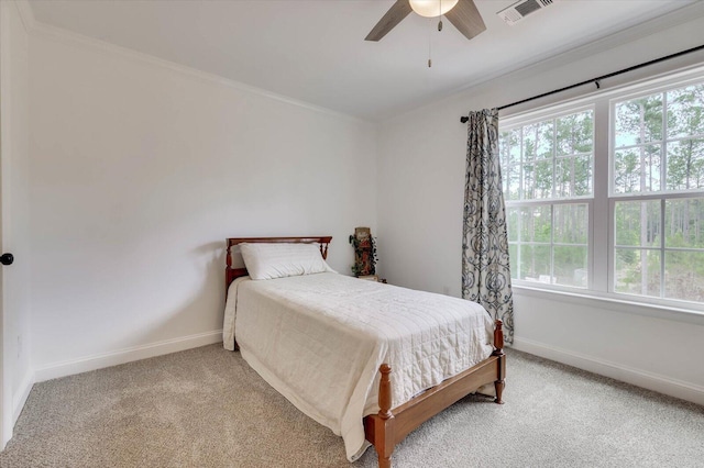 bedroom with multiple windows, ceiling fan, crown molding, and carpet floors