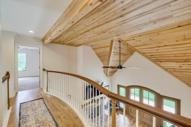 hall featuring wooden ceiling, lofted ceiling, and light hardwood / wood-style floors