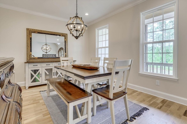 dining area with a notable chandelier, a healthy amount of sunlight, and light hardwood / wood-style flooring