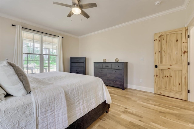 bedroom featuring ceiling fan, light hardwood / wood-style floors, and crown molding