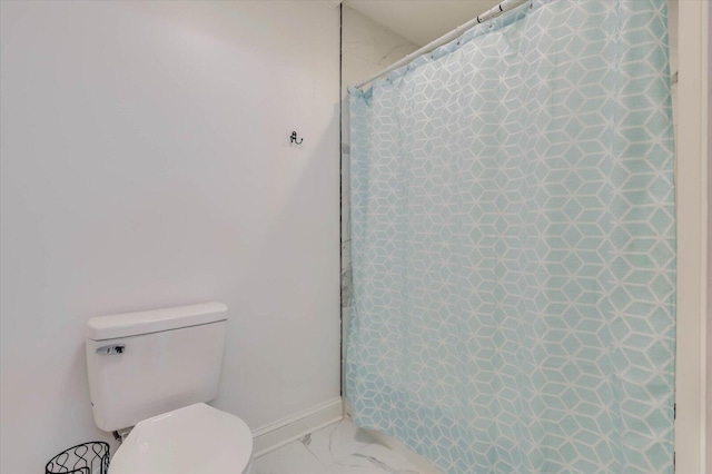 bathroom with a shower with curtain and toilet