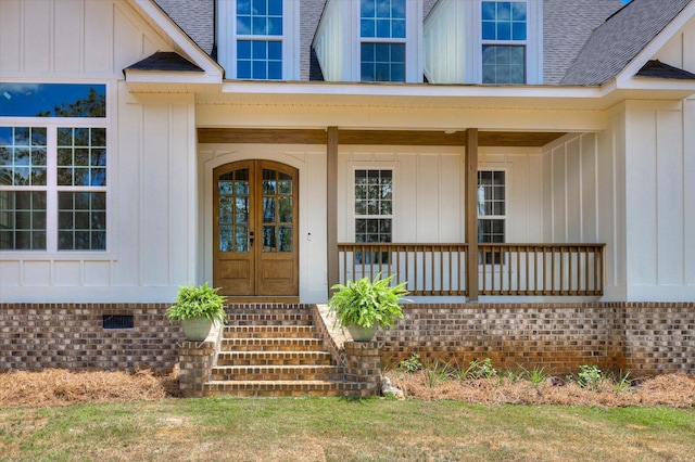 doorway to property featuring a porch and french doors