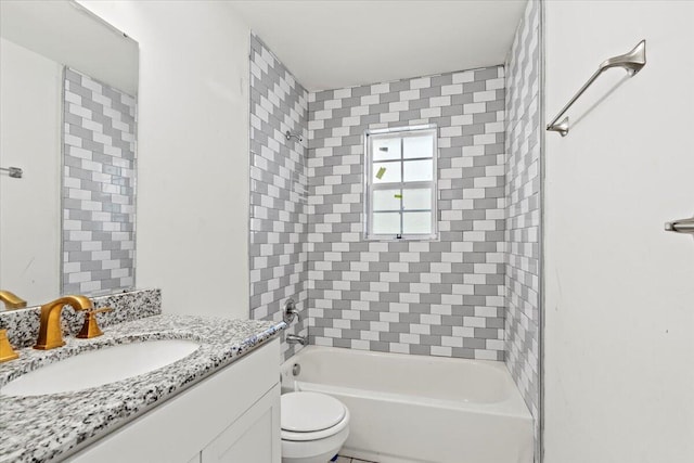 full bathroom featuring vanity, tiled shower / bath combo, and toilet