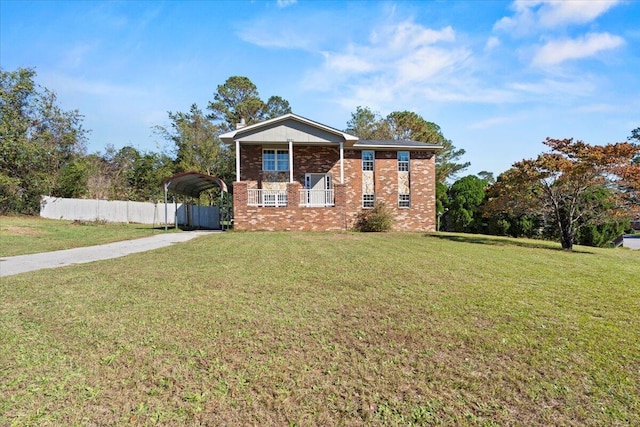 view of front facade featuring a carport, covered porch, and a front lawn