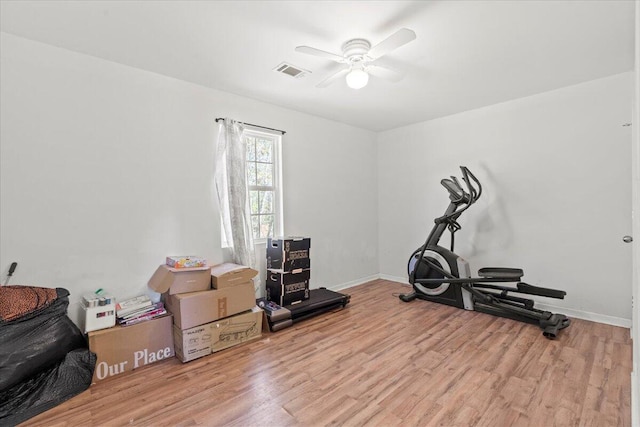 exercise area with ceiling fan and light wood-type flooring