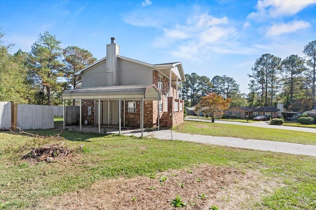 rear view of property with a lawn