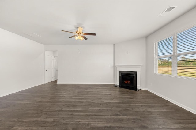 1257 Birch Cir, Grovetown, GA 30813 - unfurnished living room with ceiling fan, a warm lit fireplace, dark wood finished floors, and baseboards