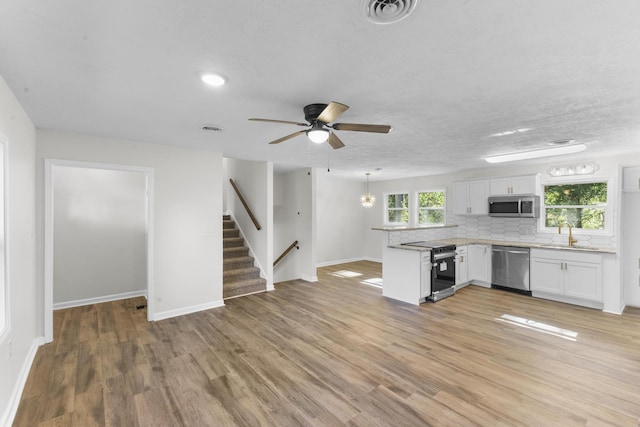 319 Indian Trl, Augusta, GA 30907 - kitchen featuring appliances with stainless steel finishes, a peninsula, light countertops, backsplash, and baseboards