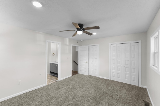 319 Indian Trl, Augusta, GA 30907 - unfurnished bedroom with multiple closets, carpet flooring, baseboards, ensuite bath, and ceiling fan