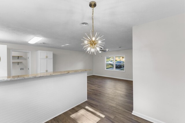319 Indian Trl, Augusta, GA 30907 - spare room featuring a chandelier, baseboards, and dark wood-type flooring