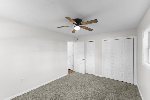 319 Indian Trl, Augusta, GA 30907 - unfurnished bedroom featuring multiple closets, carpet flooring, baseboards, and a ceiling fan