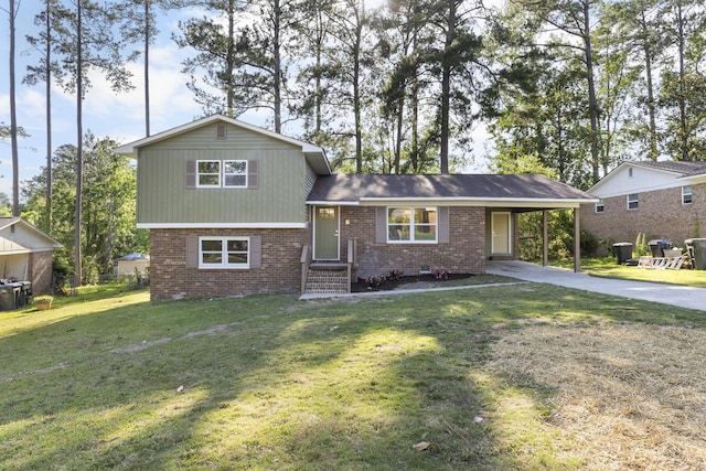 319 Indian Trl, Augusta, GA 30907 - split level home featuring concrete driveway, brick siding, an attached carport, and a front yard