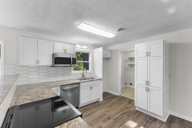 319 Indian Trl, Augusta, GA 30907 - kitchen featuring stainless steel appliances, a sink, white cabinets, dark wood-type flooring, and a textured ceiling