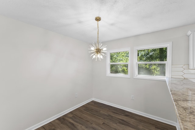 319 Indian Trl, Augusta, GA 30907 - spare room featuring a chandelier, dark wood-style floors, and baseboards