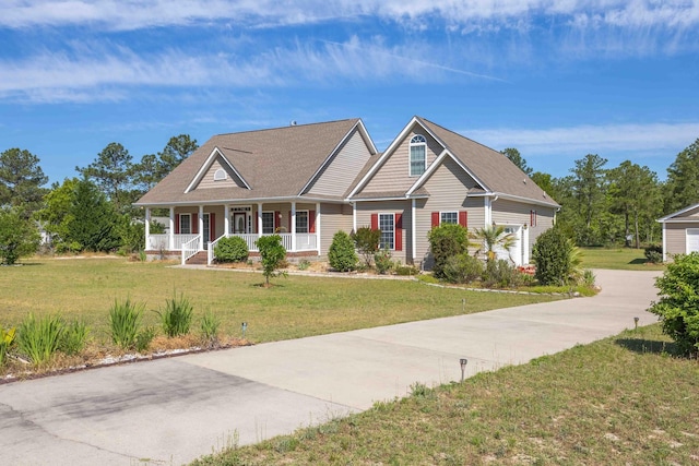 craftsman-style home with driveway, a porch, and a front yard