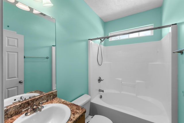 bathroom with toilet, a textured ceiling, shower / bath combination, and vanity