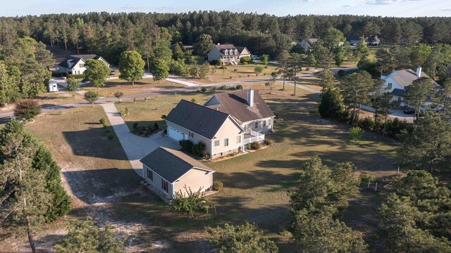view of subject property featuring a heavily wooded area