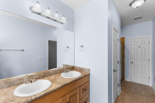 bathroom featuring tile patterned flooring and double vanity