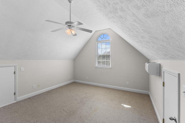 additional living space with a textured ceiling, baseboards, carpet flooring, ceiling fan, and lofted ceiling