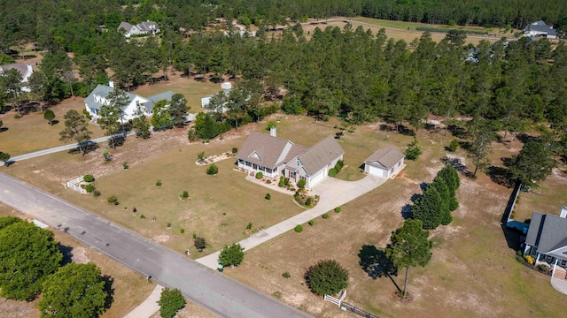 aerial view of property's location featuring a forest
