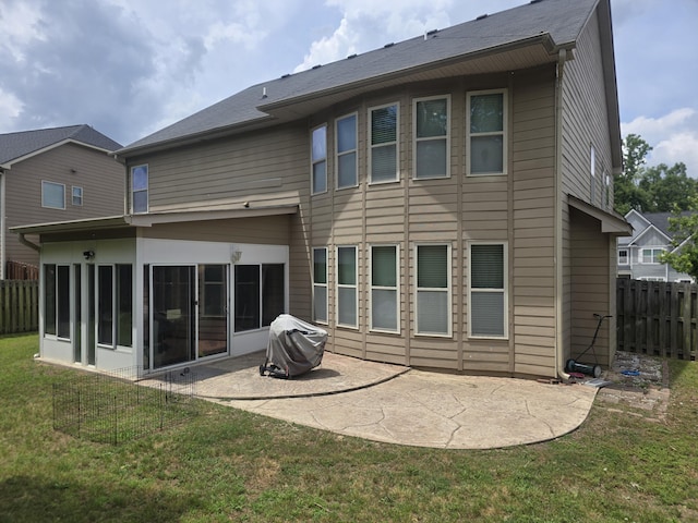 rear view of house featuring a patio and a sunroom