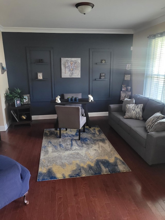 living area featuring wood finished floors, crown molding, and baseboards