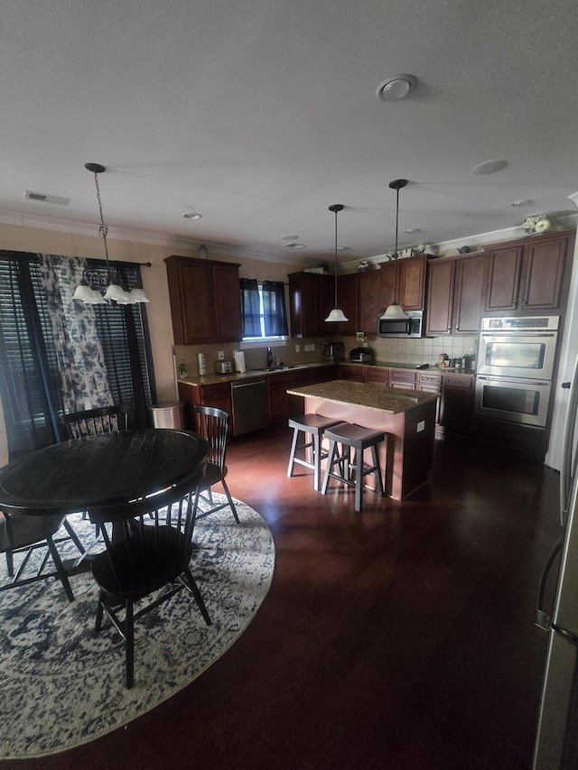 dining room with crown molding and dark wood-type flooring