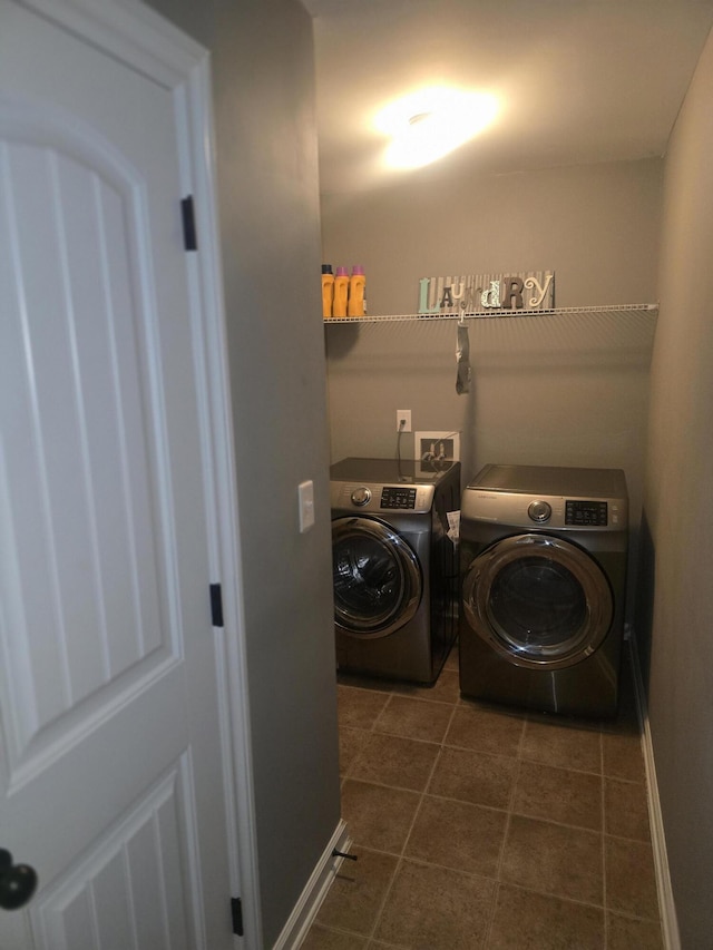 washroom with independent washer and dryer and dark tile patterned floors