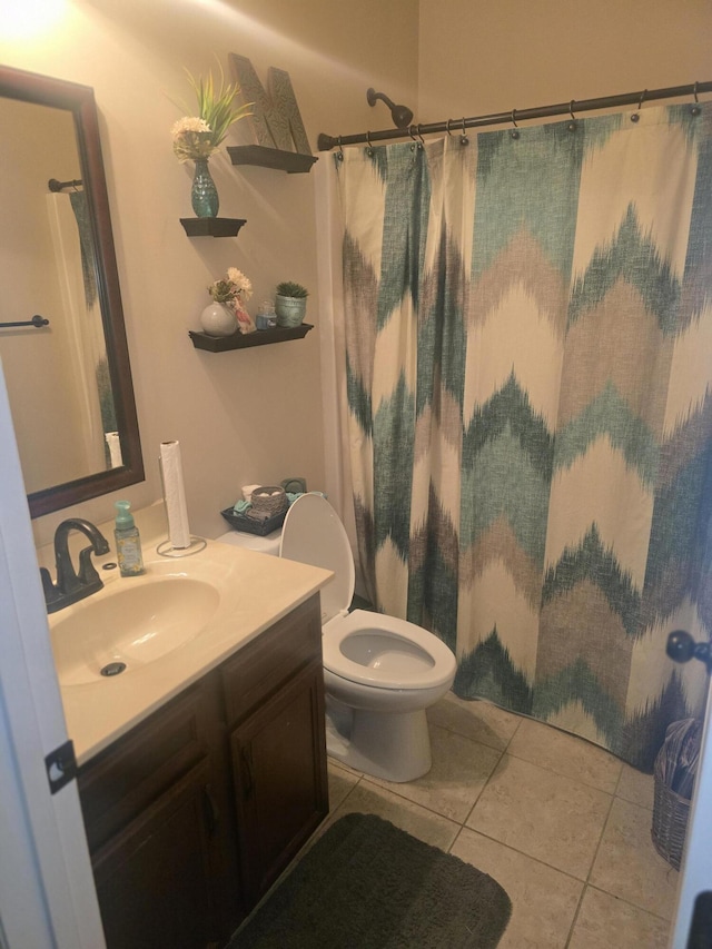 full bath featuring vanity, tile patterned flooring, toilet, and curtained shower