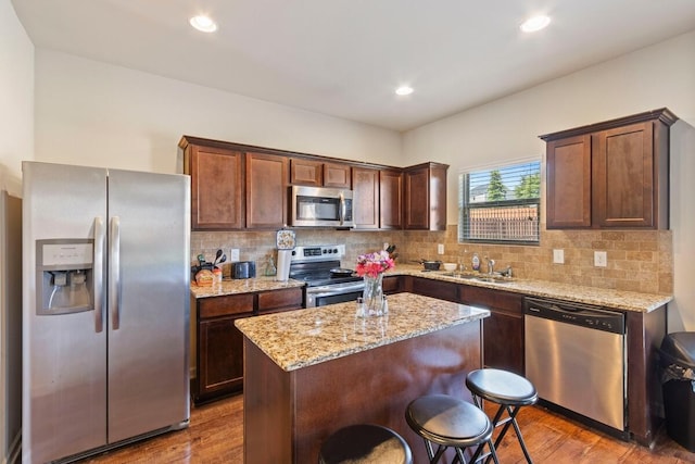 108 Sims Ct, Augusta, GA 30909 - kitchen featuring stainless steel appliances, wood finished floors, decorative backsplash, a kitchen island, and recessed lighting