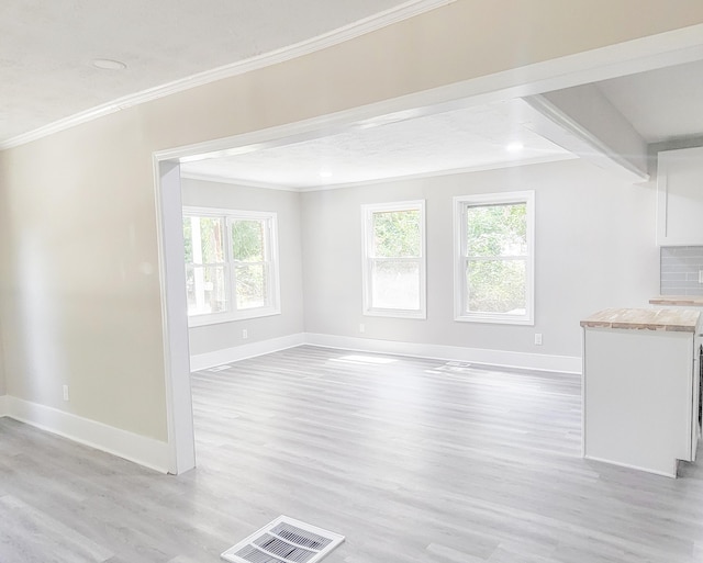 unfurnished living room with light wood-type flooring and ornamental molding