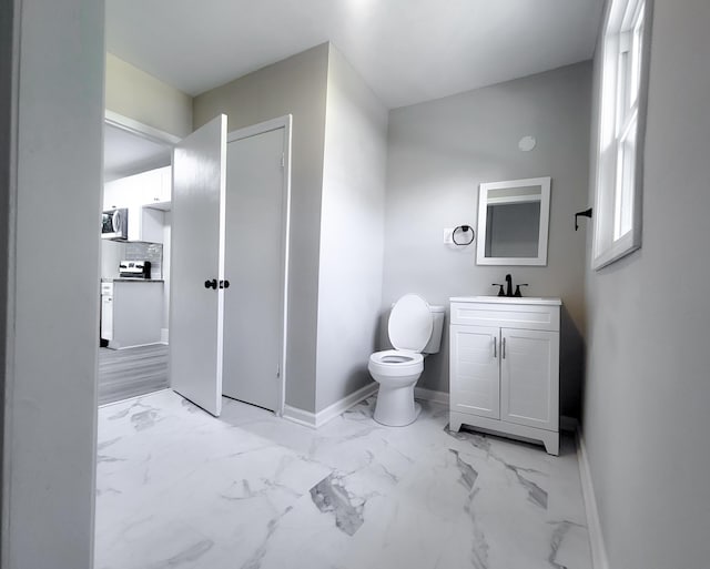 bathroom featuring decorative backsplash, vanity, and toilet